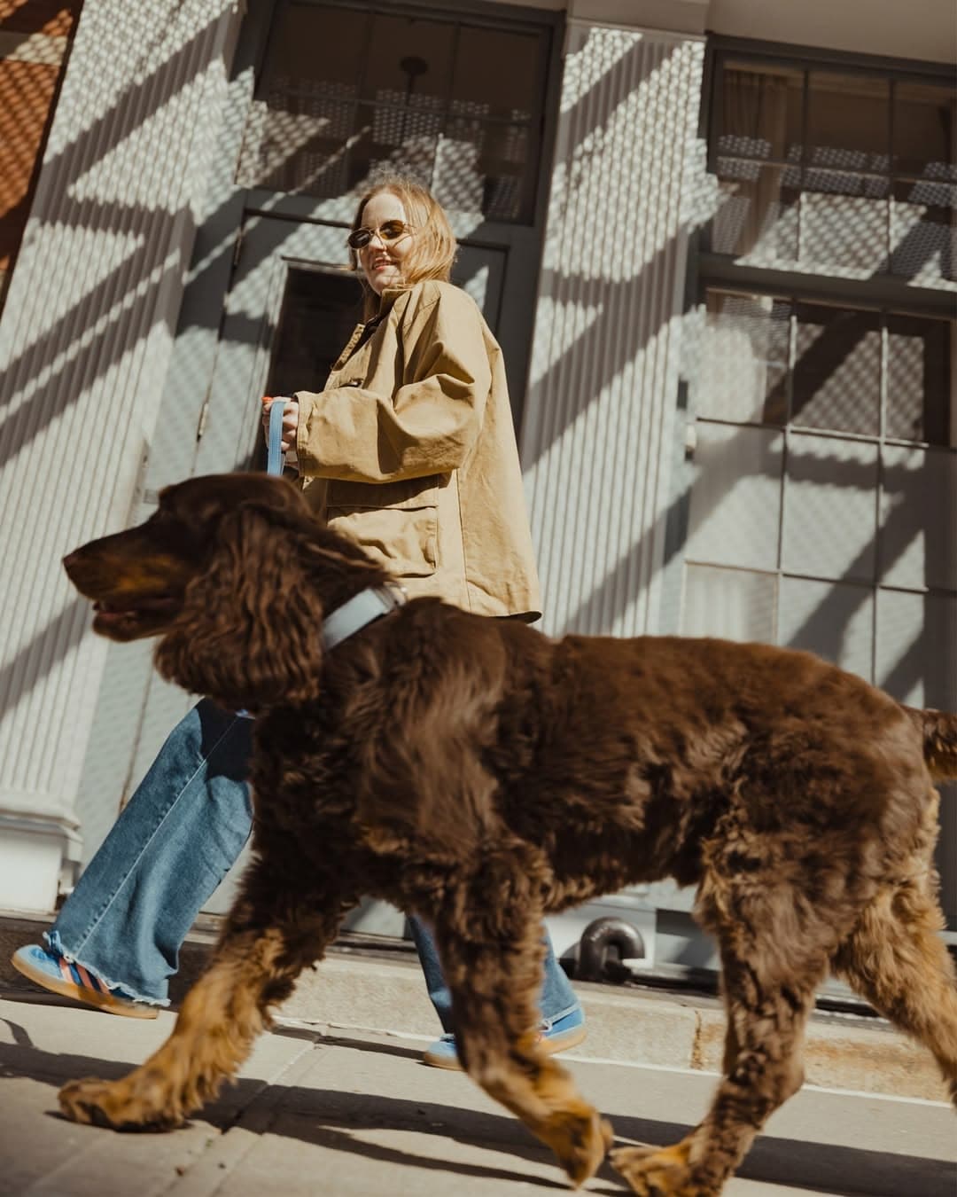 Person walking with a dog in coordinated Amu walkware.